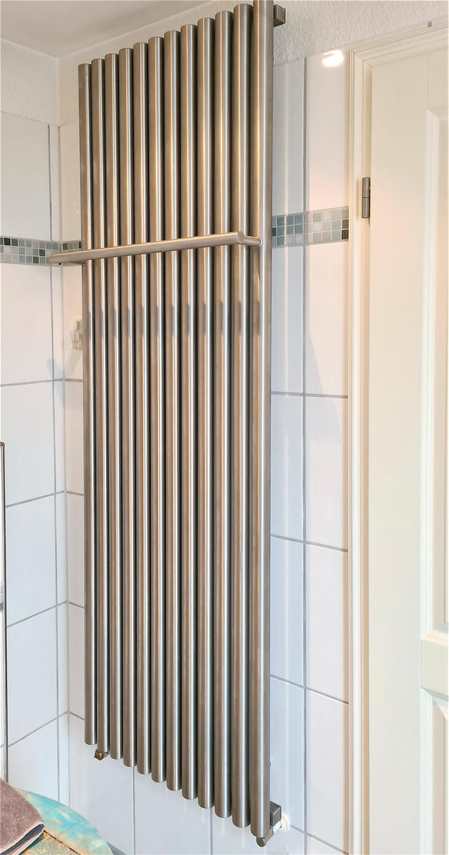 Wohlige Wärme im großen Bad mit einem Hochleistungsheizkörper aus Edelstahl V4A und praktischer Handtuchstange.